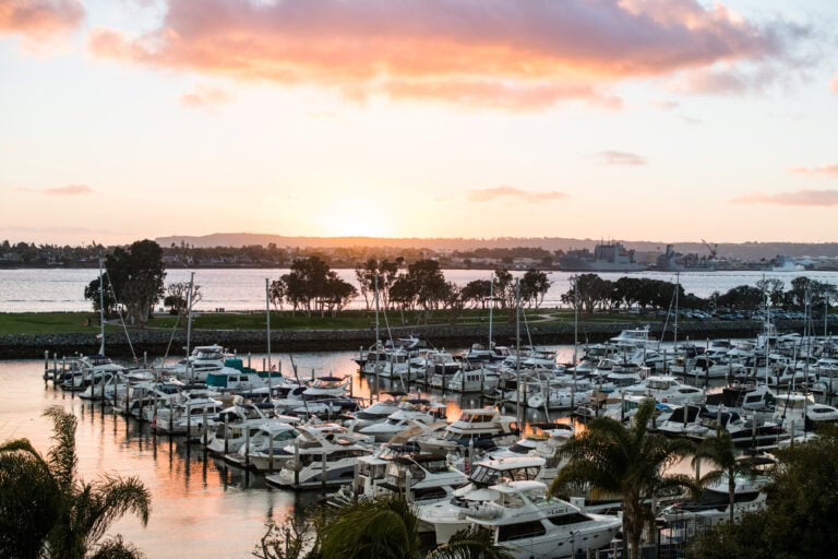 Boats docked in a harbor of the San Diego Bay at sunset