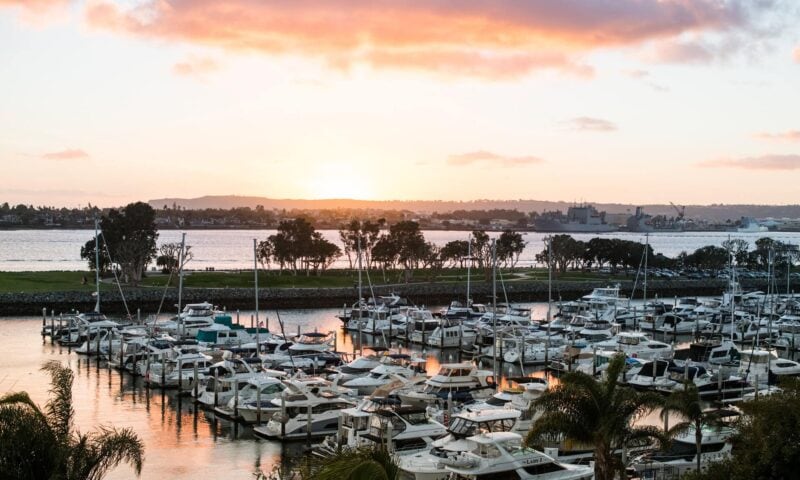 Boats docked in a harbor of the San Diego Bay at sunset