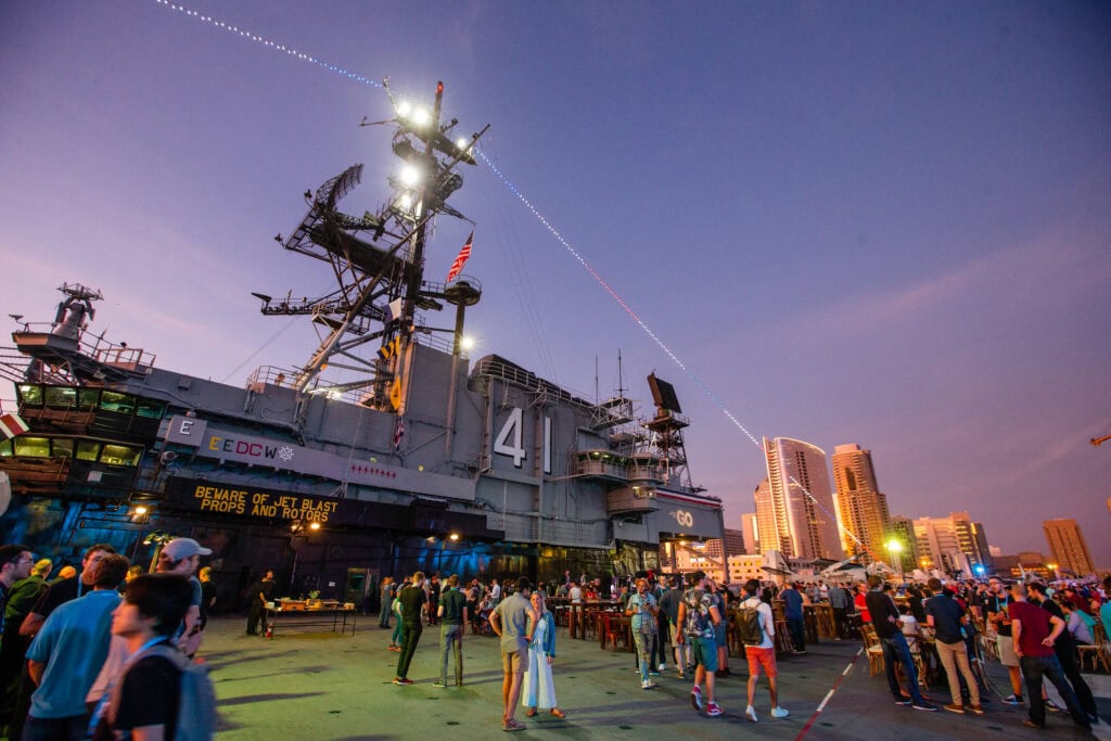 Group of people gathered for a party on the deck of a US Navy ship