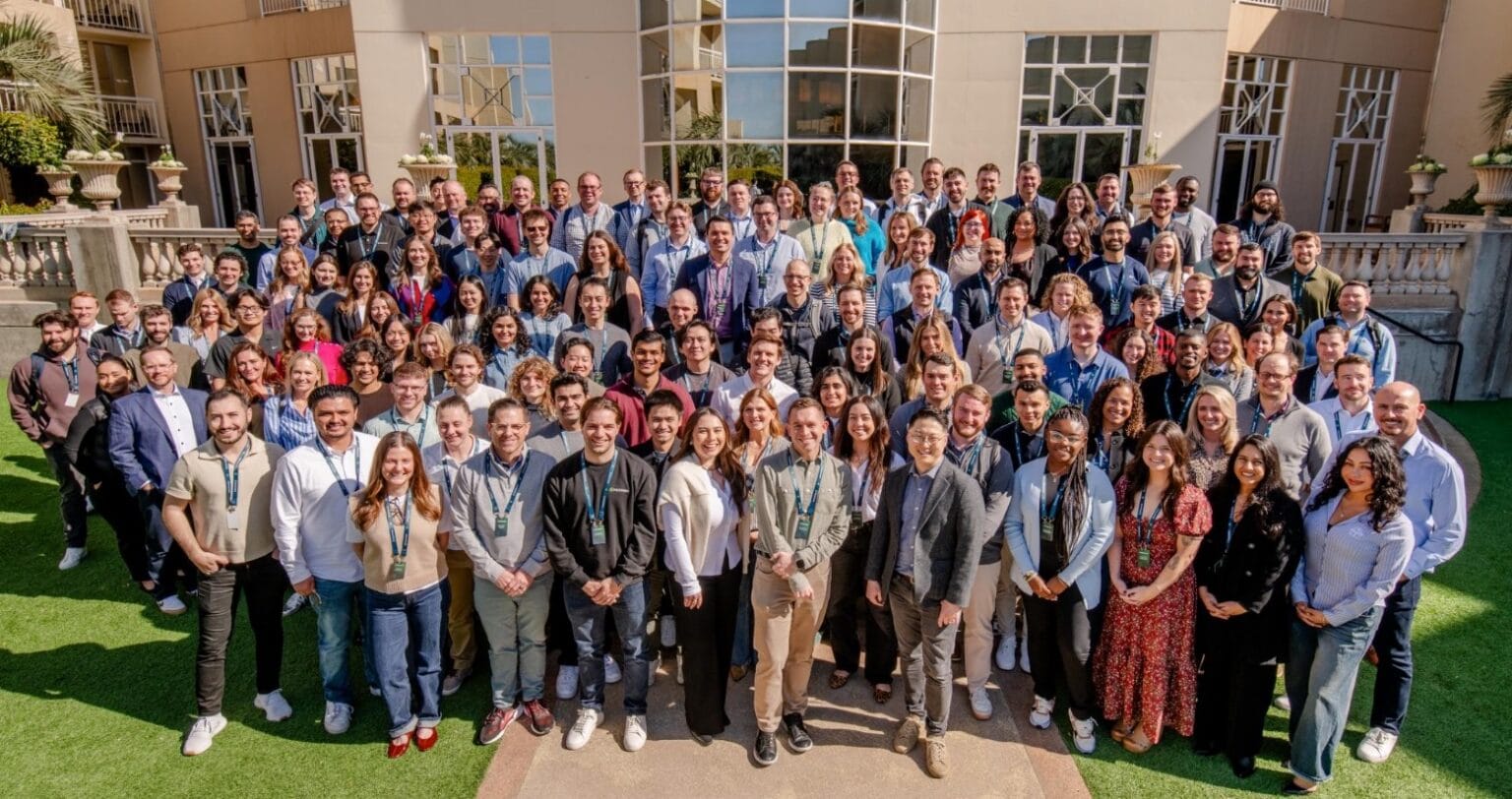 A large corporate group doing a group photo during a conference.