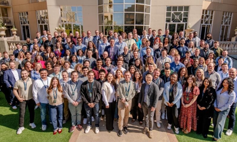 A large corporate group doing a group photo during a conference.
