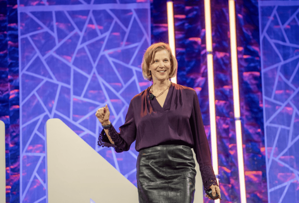 A woman walks on a brightly colored stage