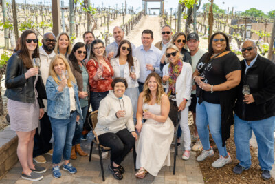 Group of people posing at a winery