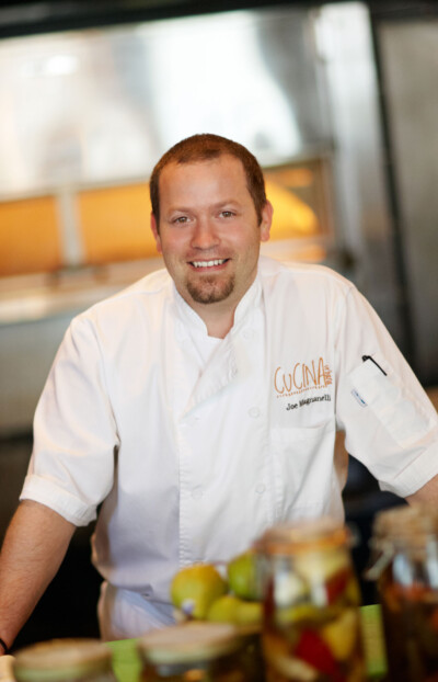 Portrait of a man in chef coat in a commercial kitchen