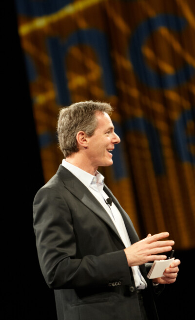 Man in a suit giving a presentation at a business conference