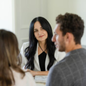 A woman at a desk interacting with clients