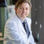 Man in a lab coat in a candid pose