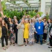 A group of people in a fun and energetic pose during a corporate event