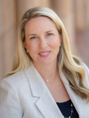 Headshot of a woman in a white blazer