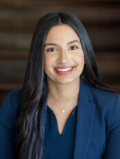 Headshot of a woman with dark hair and a dark blazer